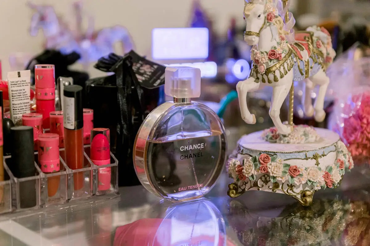 a glass table topped with a bottle of perfume