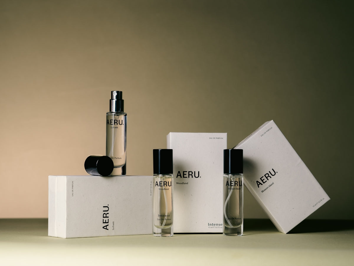 a couple of bottles of perfume sitting on top of a box